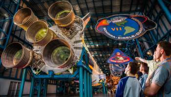 family looking at the Saturn V Rocket at Kennedy Space Center
